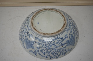 A large Japanese blue and white decorated charger, 47cm diameter. Condition - riveted and chips to rim